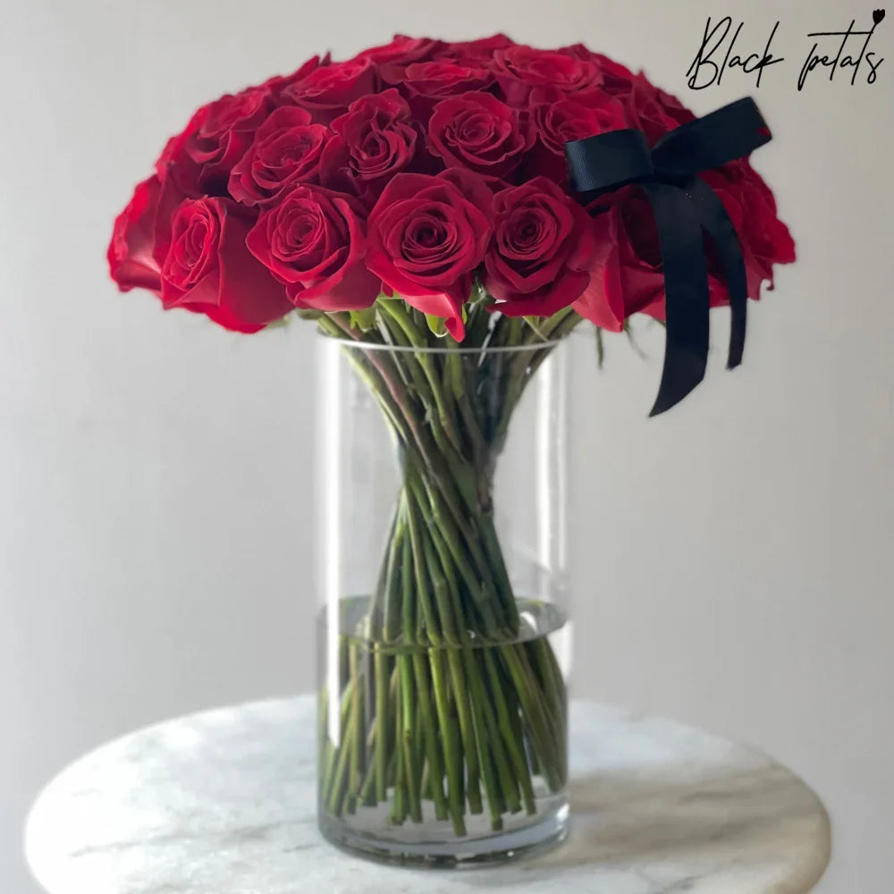 Roses And Stems In A Glass Vase